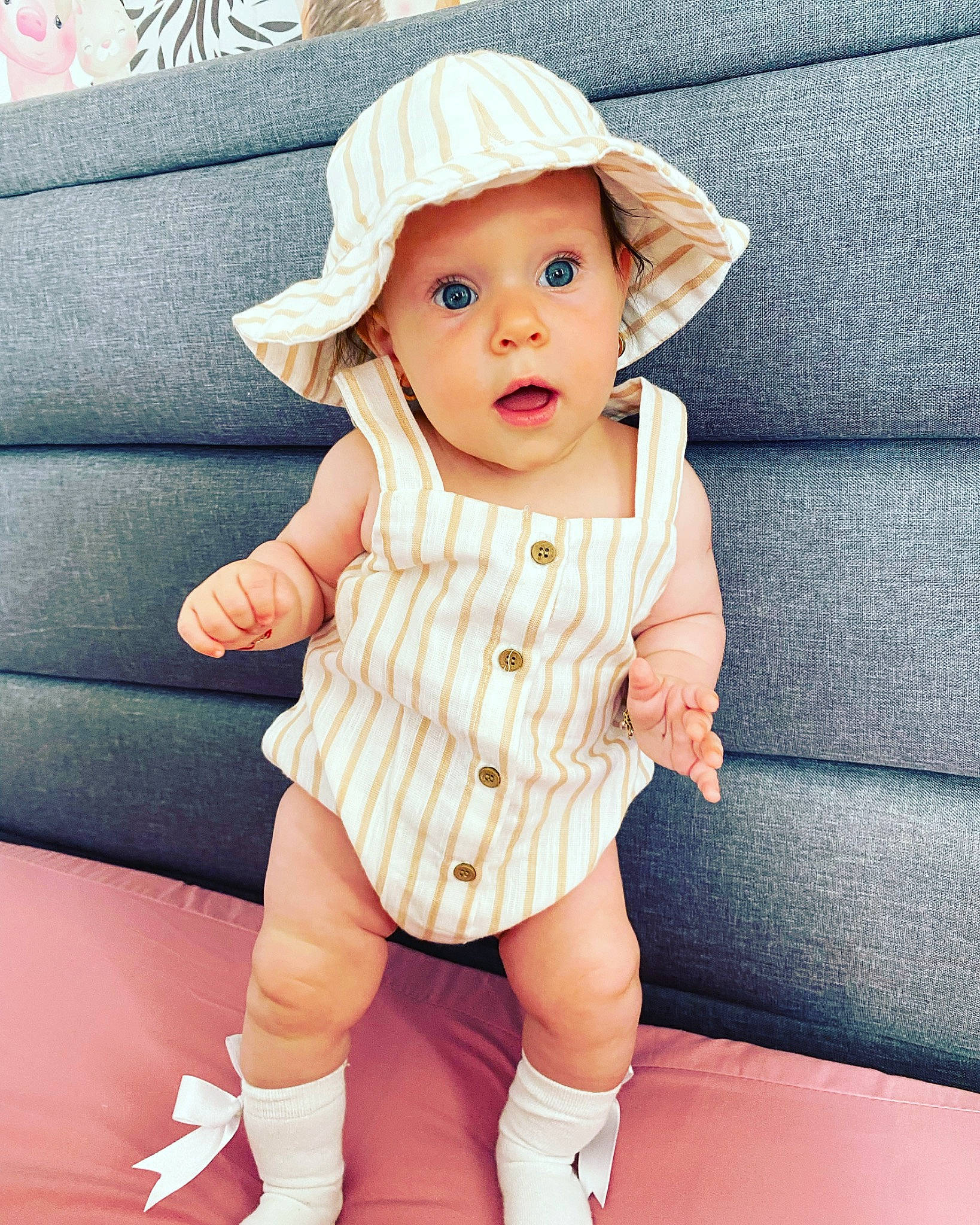 Eva joined the competition — help win amazing prizes! baby, baby_toddler_clothing, blue, cap, collar, cool, dress, eye, face, facial_expression, happy, hat, headwear, one_piece_garment, person, pink, skin, sleeve, sun_hat, surprise