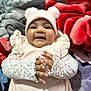 Wahenoor joined the competition — help win amazing prizes! adorable, baby, blanket, child, clapping, closeup, cozy, cute, floral_clothing, hands, happy, headwear, indoor, infant, pink_hat, pom_poms, portrait, smiling, soft_texture, warm