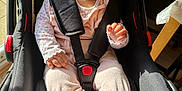 Wahenoor is registered to the contest to win money with this photo: baby, beanie, car_seat, child, clothing, cozy, cute, face, hand, indoor, infant, person, pink_socks, portrait, seatbelt, smiling, soft_toys, sunlight, toddler, warm_clothing