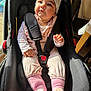 baby, beanie, car_seat, child, clothing, cozy, cute, face, hand, indoor, infant, person, pink_socks, portrait, seatbelt, smiling, soft_toys, sunlight, toddler, warm_clothing
