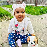 Wahenoor joined the competition — help win amazing prizes! baby, child, clothing, cute, dog_toy, fence, grass, happy, hat, nature, outdoor, pavement, person, plush_toy, portrait, sitting, smiling, socks, toddler, toy
