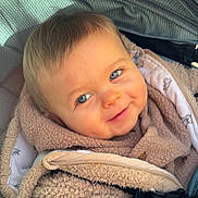 Thiam participe au concours pour gagner de l'argent avec cette photo : baby, blue_eyes, smile, fleece, beige_clothing, stroller, canopy, child, cute, infant, warm_clothing, face, portrait, candid, outdoor, comfort, closeup, happy, small_child, soft_texture