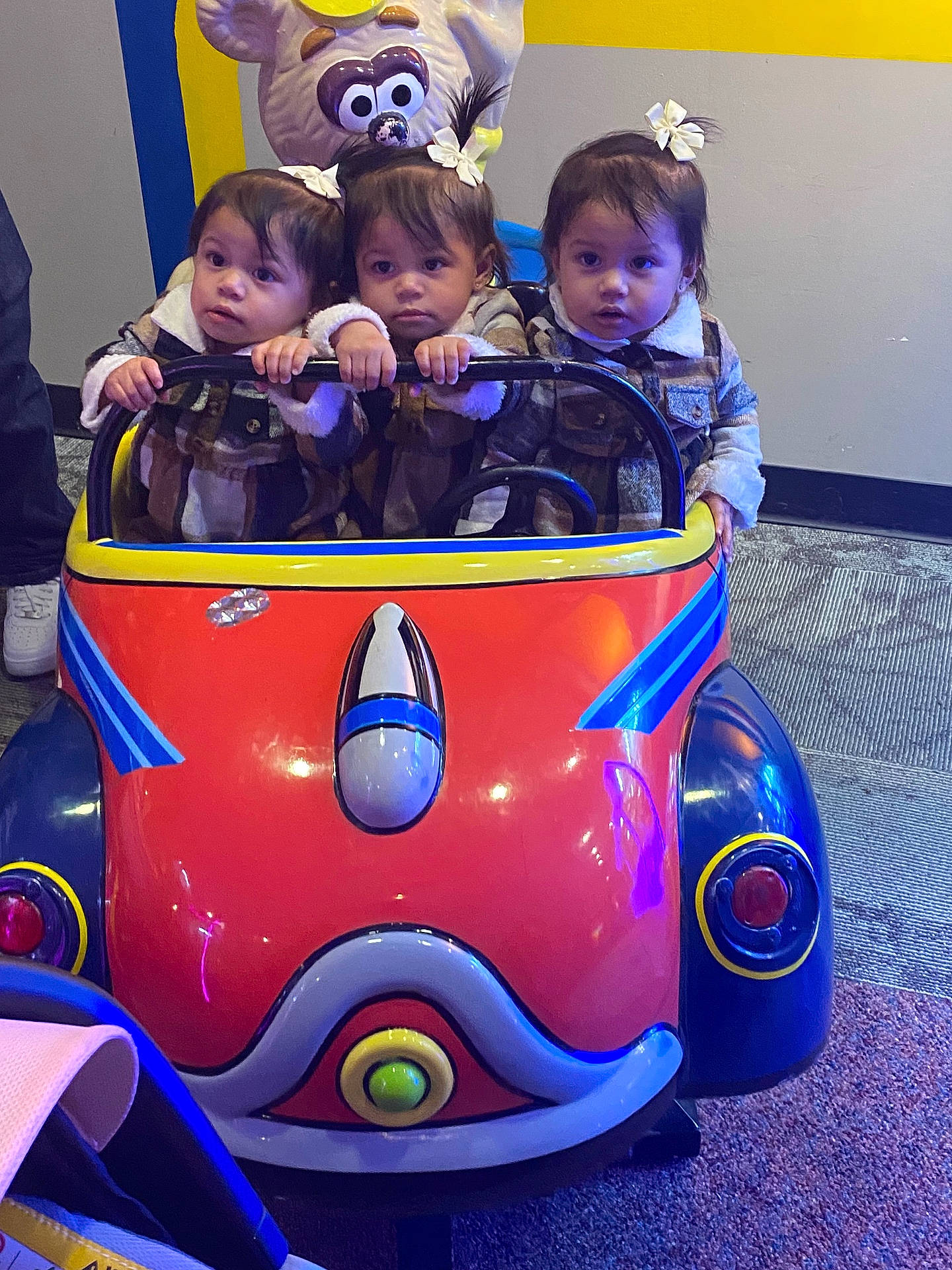 amusementpark, baby, car, clothing, face, footwear, head, indoors, machine, outdoors, people, person, photography, playarea, portrait, purple, shoe, transportation, vehicle, wheel