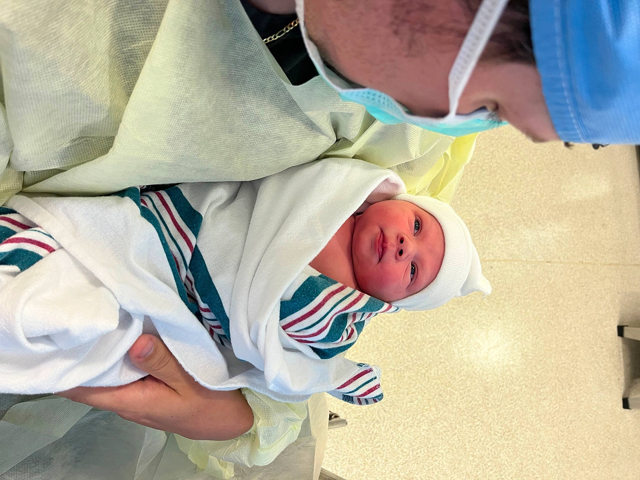 Tate is registered to the contest to win money with this photo: baby, baby_toddler_clothing, child, comfort, elbow, gesture, happy, headwear, person, room, sitting, sleeve, toddler