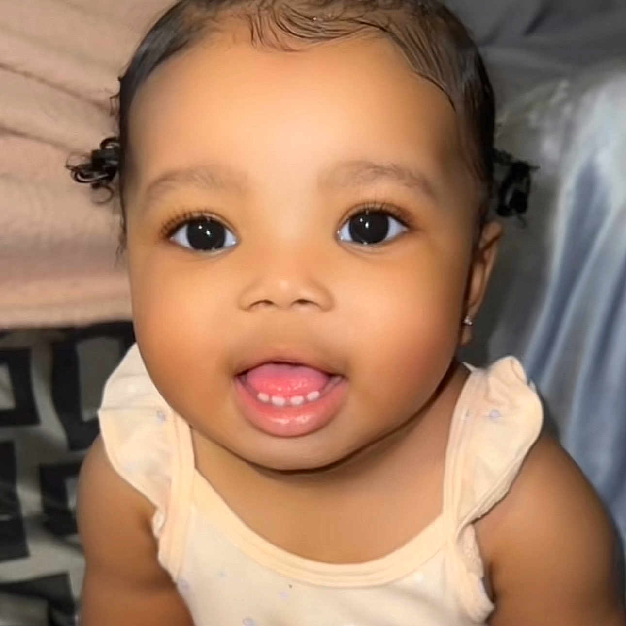 Lela Bennett joined the competition — help win amazing prizes! adorable, apparel, baby, blanket, child, closeup, couch, curly_hair, cute, face, happy, home, indoor, infant, person, portrait, skin, sleeveless, smiling, young_child