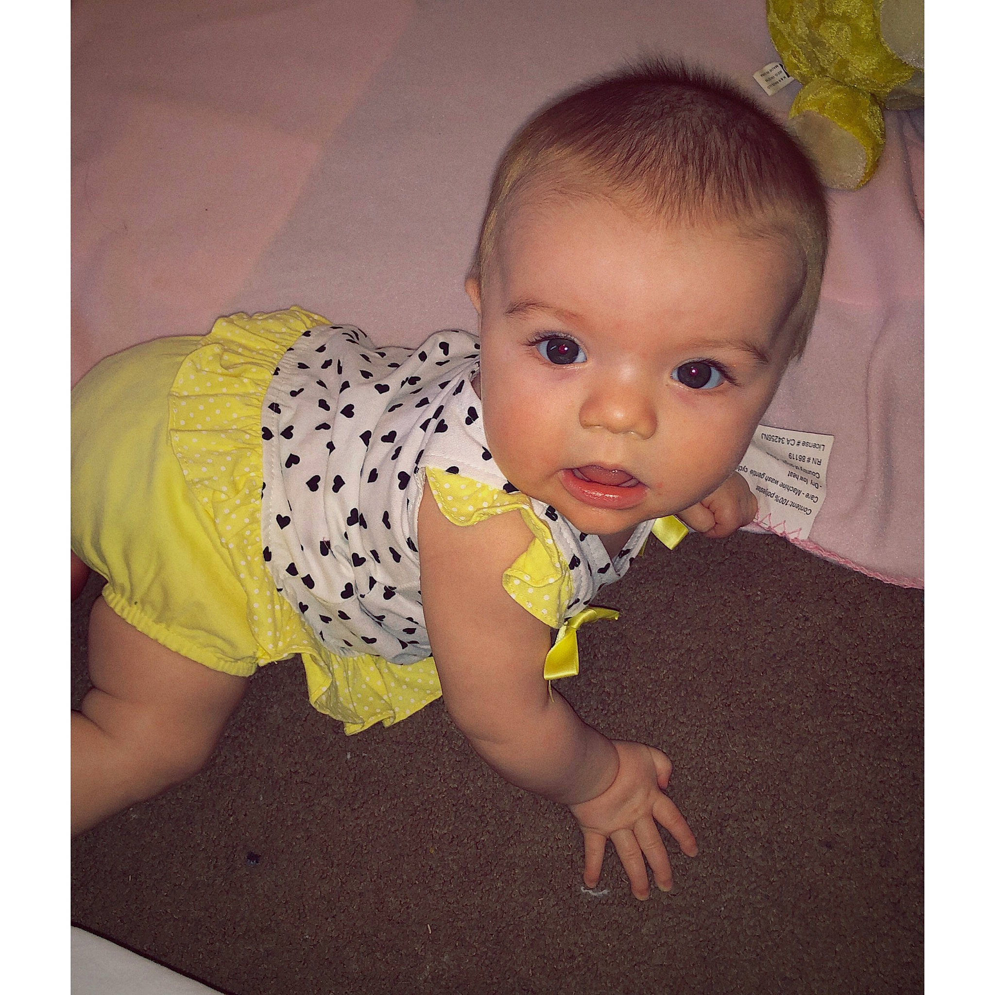 Brenleigh is registered to the contest to win money with this photo: baby, baby_products, baby_toddler_clothing, cheek, child, dress, eye, face, head, lip, mouth, nose, person, photography, product, sitting, skin, snapshot, toddler, tummy_time