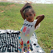 Adalynn is registered to the contest to win money with this photo: child, grass, water, blanket, sandals, outdoor, toddler, clothing, colorful, pose, playful, sunlight, nature, happy_easter, patterned_pants, smiling, daylight, relaxation, casual, summer