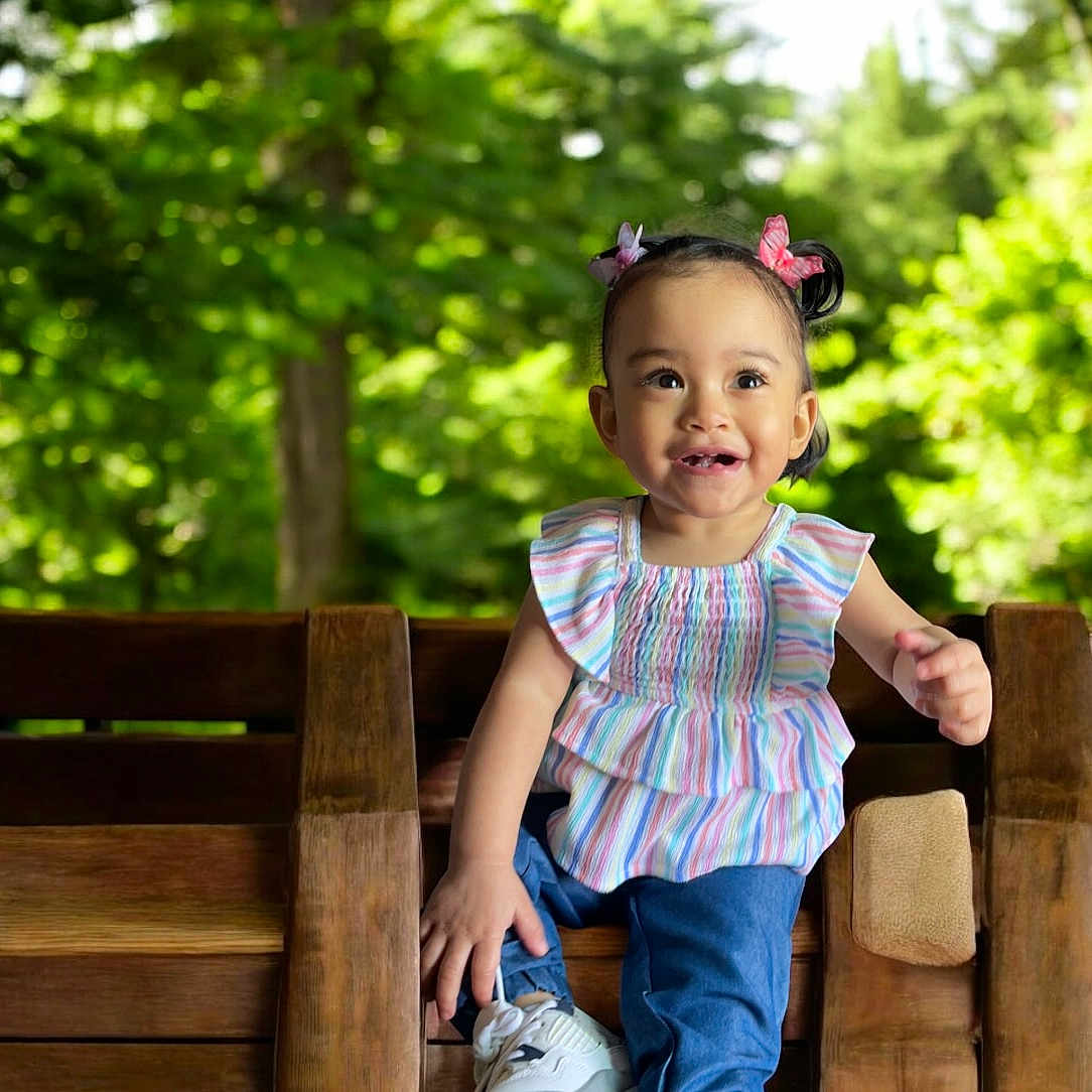 Hunter joined the competition — help win amazing prizes! bench, child, clothing, face, female, footwear, furniture, girl, happy, head, jeans, pants, person, photography, plant, portrait, sitting, smile, tree, wood