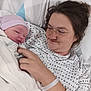 Mckinley is registered to the contest to win money with this photo: newborn, baby, mother, hospital, bed, blanket, hat, woman, person, family, love, hospital_gown, skin, hand, face, lying_down, medical_bracelet, comfort, parent, newborn_baby