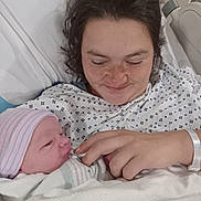 Mckinley is registered to the contest to win money with this photo: newborn, baby, mother, hospital_bed, hospital_gown, blanket, face, person, infant, love, family, newborn_hat, hand, bed, healthcare, smile, skin, human, hospital, comfort