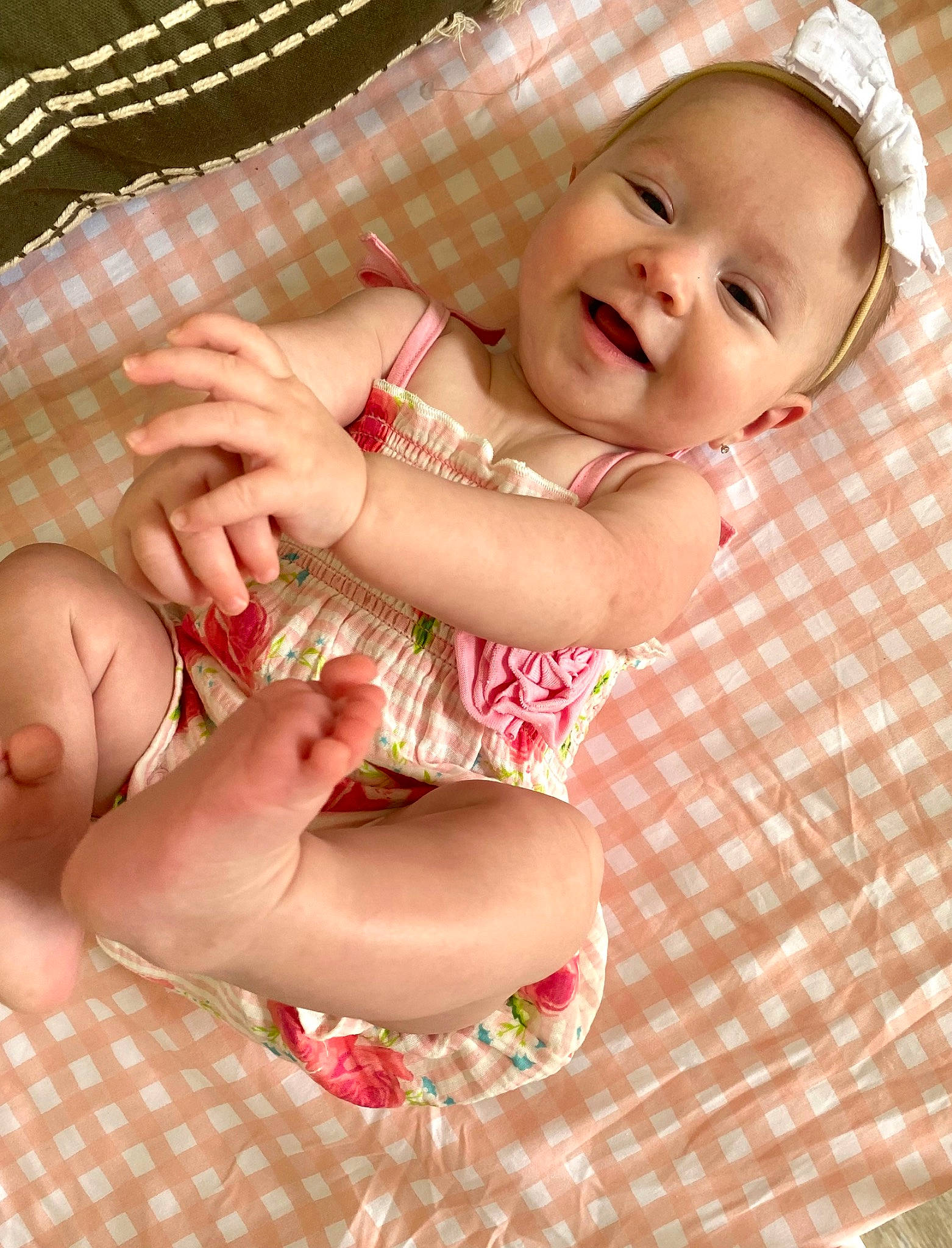 Parker Collins is registered to the contest to win money with this photo: arm, baby, baby_toddler_clothing, cheek, eye, facial_expression, finger, gesture, hand, happy, human_body, lip, mouth, person, pink, product, skin, smile, stomach, thumb