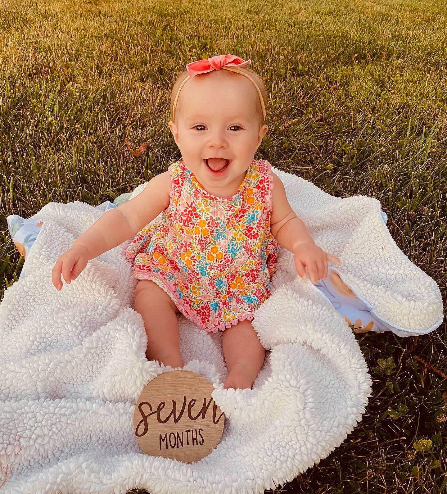 Parker Collins joined the competition — help win amazing prizes! baby, baby_toddler_clothing, child, day_dress, dress, eye, face, fun, grass, grass_family, happy, head, pattern, people_in_nature, person, pink, portrait_photography, sitting, smile, toddler