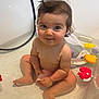 baby, bathtub, water, child, toy, bath_toy, pink_cup, wet_hair, smiling, sitting, playful, cute, indoor, bathroom, skin, face, happy, chubby_cheeks, infant, toddler