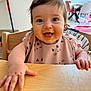 baby, child, high_chair, messy_face, food, smiling, happy, indoor, table, bib, hand, tongue_out, hair, person, furniture, kitchen, cute, infant, playful, expression