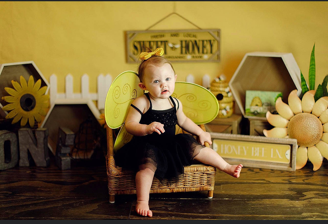Brooklynn is registered to the contest to win money with this photo: baby, child, couch, fashion_accessory, flash_photography, flooring, flower, fun, happy, human_leg, illustration, leisure, person, petal, plant, room, rose, sitting, toddler, toy