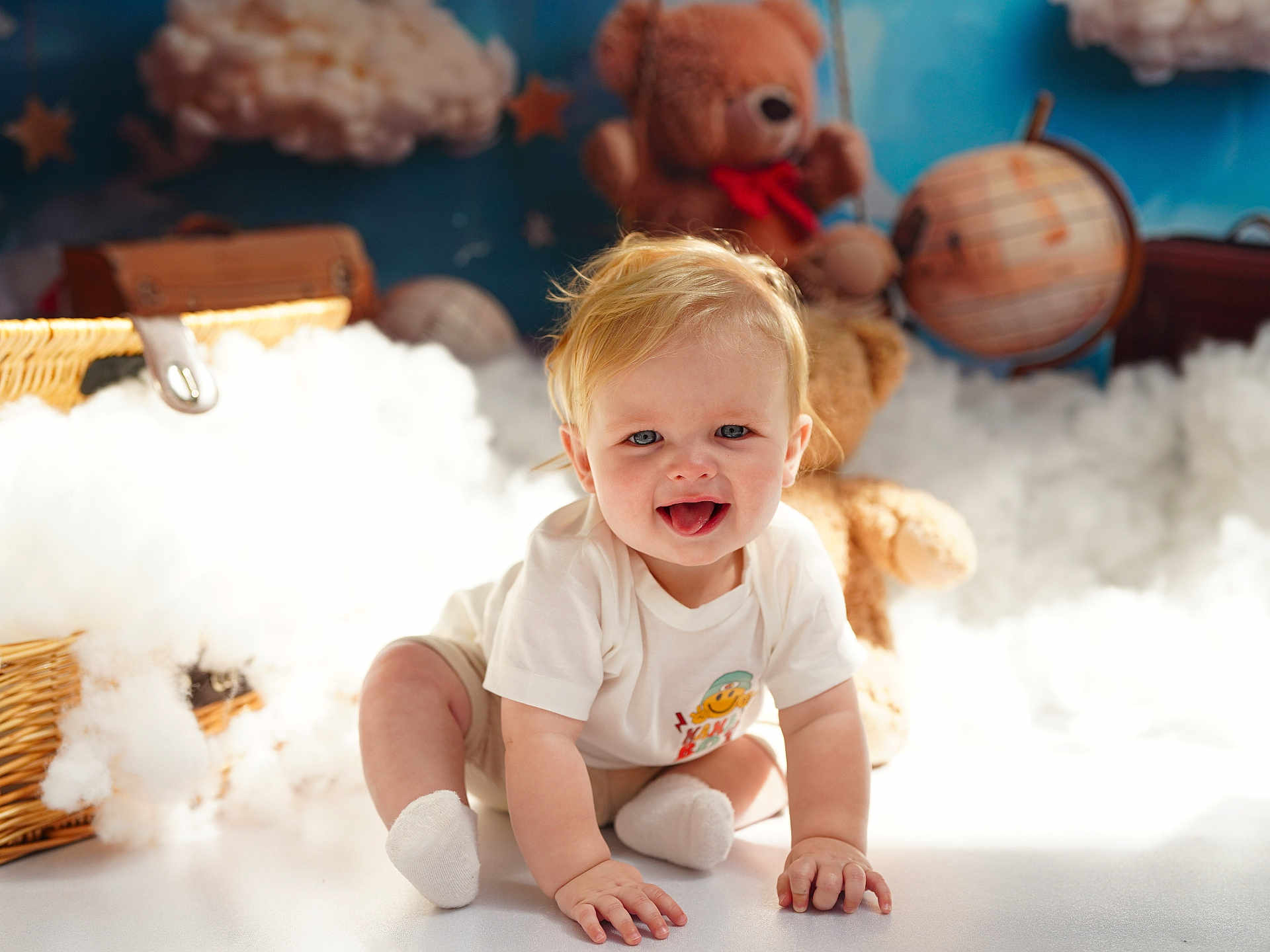 Jaxon joined the competition — help win amazing prizes! baby, blonde_hair, blue_eyes, crawling, white_socks, white_shirt, teddy_bear, stuffed_animal, globe, cotton_clouds, basket, indoor, child, smiling, cute, playful, soft_lighting, nursery, floor, toy