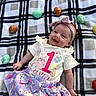baby, child, smiling, plaid_blanket, easter_eggs, headband, purple_skirt, shirt, outdoor, holiday, celebration, cute, infant, lying_down, festive, spring, colorful, happy, person, portrait