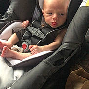 Azrael joined the competition — help win amazing prizes! baby, car_seat, infant, child, tongue_out, seatbelt, car_interior, clothing, head, face, sitting, safety, restraint, young_child, infant_clothing, expression, cute, padded_seat, newborn, person
