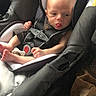 baby, car_seat, infant, child, tongue_out, seatbelt, car_interior, clothing, head, face, sitting, safety, restraint, young_child, infant_clothing, expression, cute, padded_seat, newborn, person
