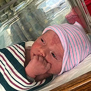 Azrael joined the competition — help win amazing prizes! newborn, baby, hospital, blanket, hat, bassinet, infant, person, bed, sleeping, wrapped, striped, cute, face, hand, nursery, child, indoors, healthcare, patient