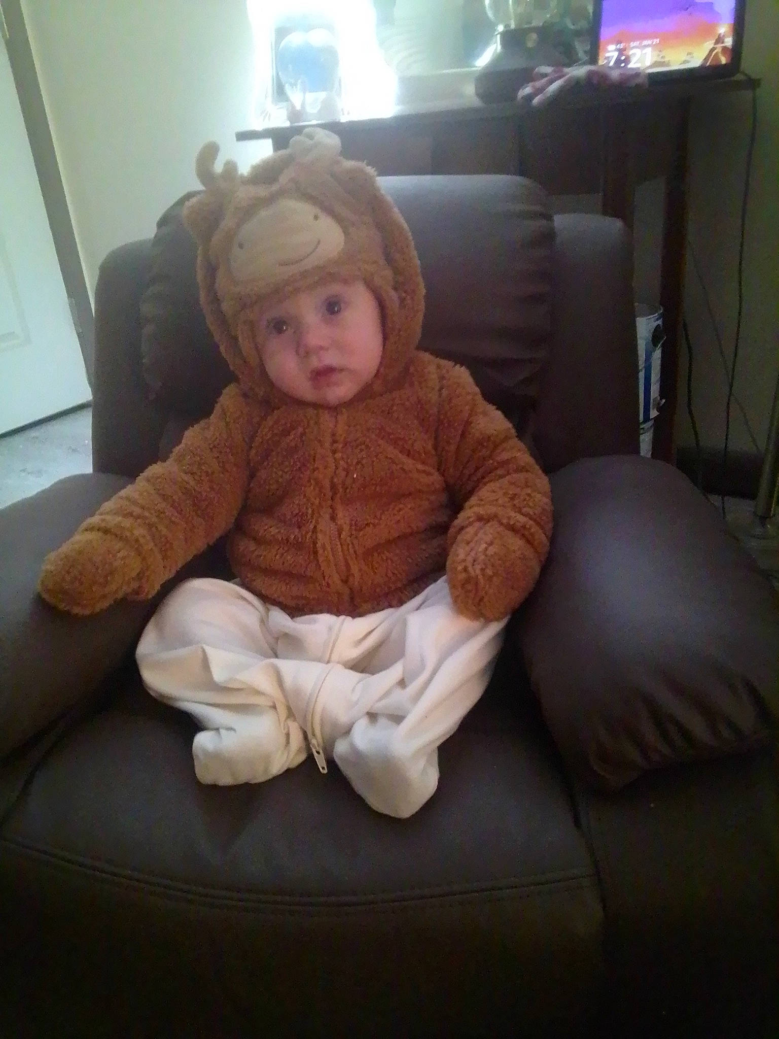 Koda joined the competition — help win amazing prizes! baby, baby_toddler_clothing, chair, child, comfort, couch, floor, flooring, fur, headwear, human_leg, knee, lap, linens, living_room, person, pillow, room, sitting, sleeve