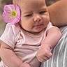 arm, baby, blurred_background, candid, cute, ear, face, flower, hand, head, infant, nature, outdoor, person, pink_onesie, portrait, relaxed, resting, skin, striped_shirt