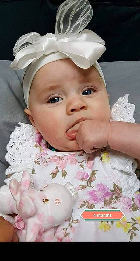 Aleigha is registered to the contest to win money with this photo: baby, cheek, child, ear, face, fashion_accessory, forehead, hair_accessory, head, headband, headgear, headpiece, headwear, lip, mouth, nose, person, pink, skin, toddler