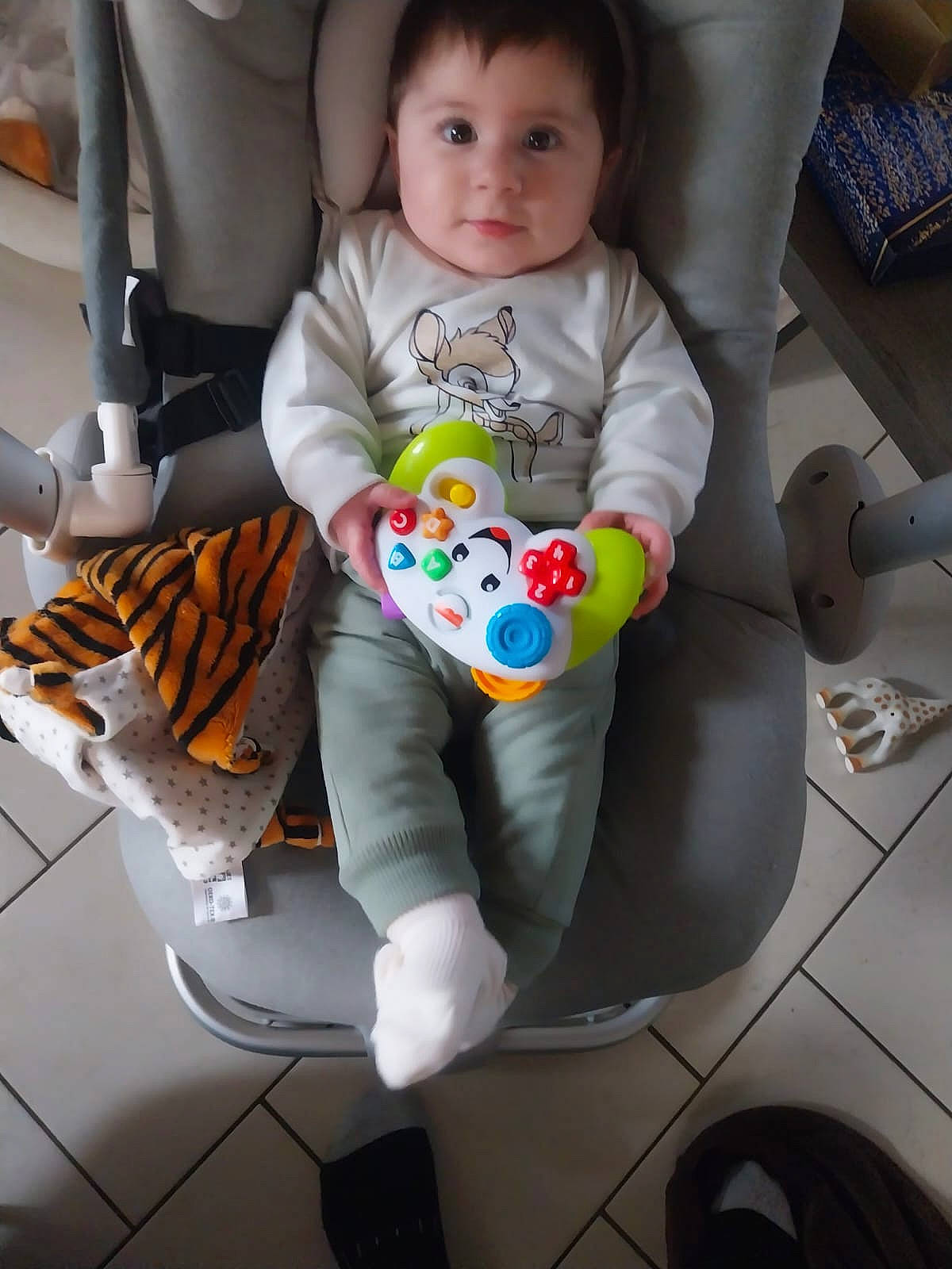 baby, chair, clothing, coat, couch, cushion, face, footwear, furniture, head, homedecor, hosiery, pants, person, photography, portrait, shoe, sitting, sock, toy