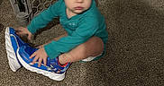 Vincent joined the competition — help win amazing prizes! baby, baby_gate, blue_shoes, blur, carpet, child, clothing, curious, diaper, floor, footwear, furniture, home, indoor, motion, person, sitting, sneakers, toddler, toy