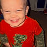 baby, blurry, camo_pattern, carpet, child, cute, dinosaur, door, hand, happy, indoor, motion, person, playful, red_shirt, room, short_hair, smile, standing, toddler