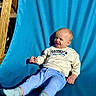 Reuben joined the competition — help win amazing prizes! baby, child, smiling, happy, portrait, sitting, chair, outdoor, sunlight, blue_background, clothing, sweater, pants, socks, brooklyn, face, person, infant, relaxed, photography
