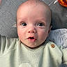 Reuben is registered to the contest to win money with this photo: baby, infant, face, eyes, sweater, clothing, duck, toy, expression, curious, closeup, portrait, child, skin, head, mouth, button, fabric, texture, indoor
