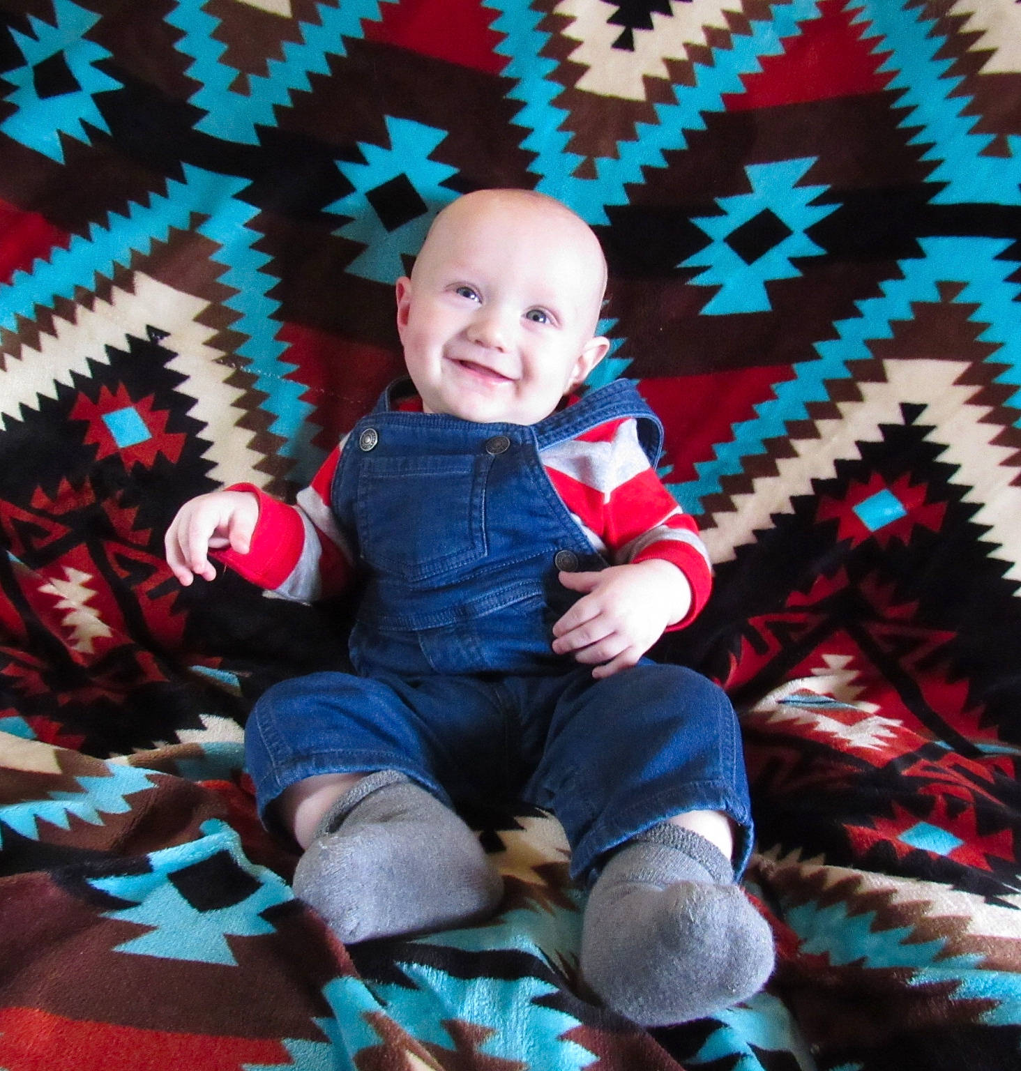 Henry is registered to the contest to win money with this photo: baby, baby_toddler_clothing, child, joy, pattern, person, sitting, smile, toddler
