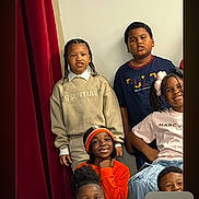 Razir is registered to the contest to win money with this photo: child, children, group, portrait, indoor, smiling, casual_clothing, video_call, phone_screen, curtain, diverse, face, person, young, head, expression, technology, communication, interaction, friends