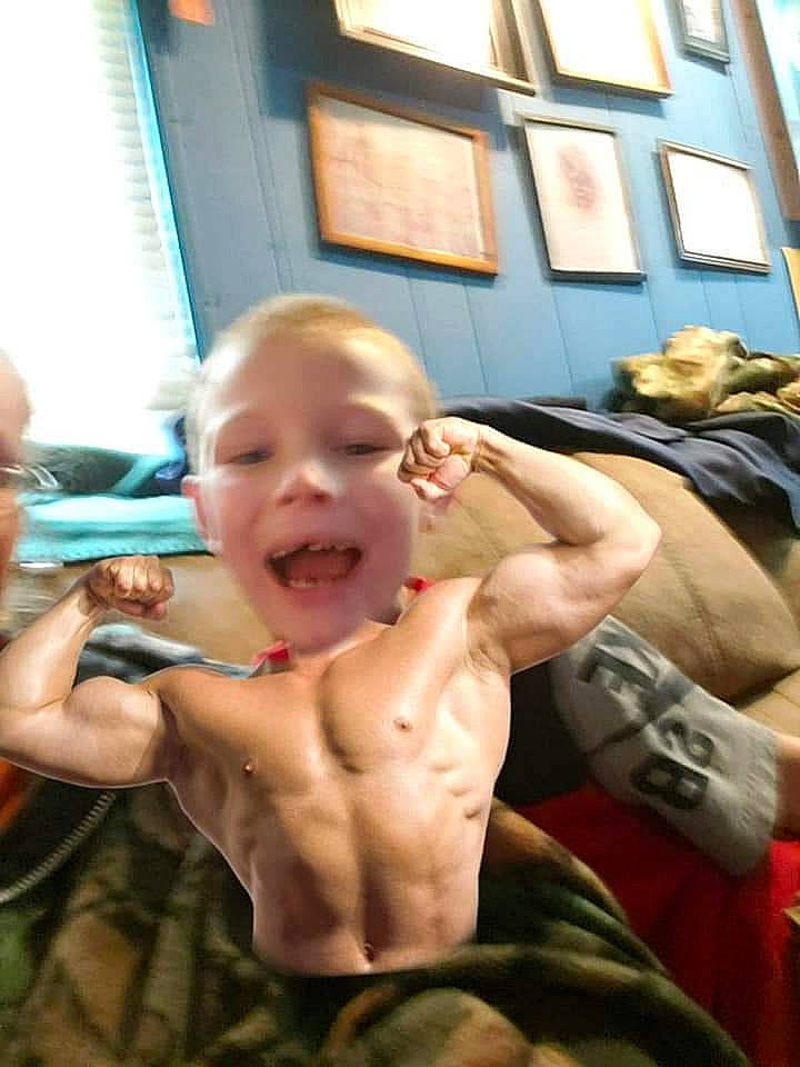 Hunter is registered to the contest to win money with this photo: barechested, chest, comfort, event, finger, fun, gesture, happy, jaw, joint, joy, luggage_and_bags, mouth, muscle, person, picture_frame, room, smile, thumb, toddler