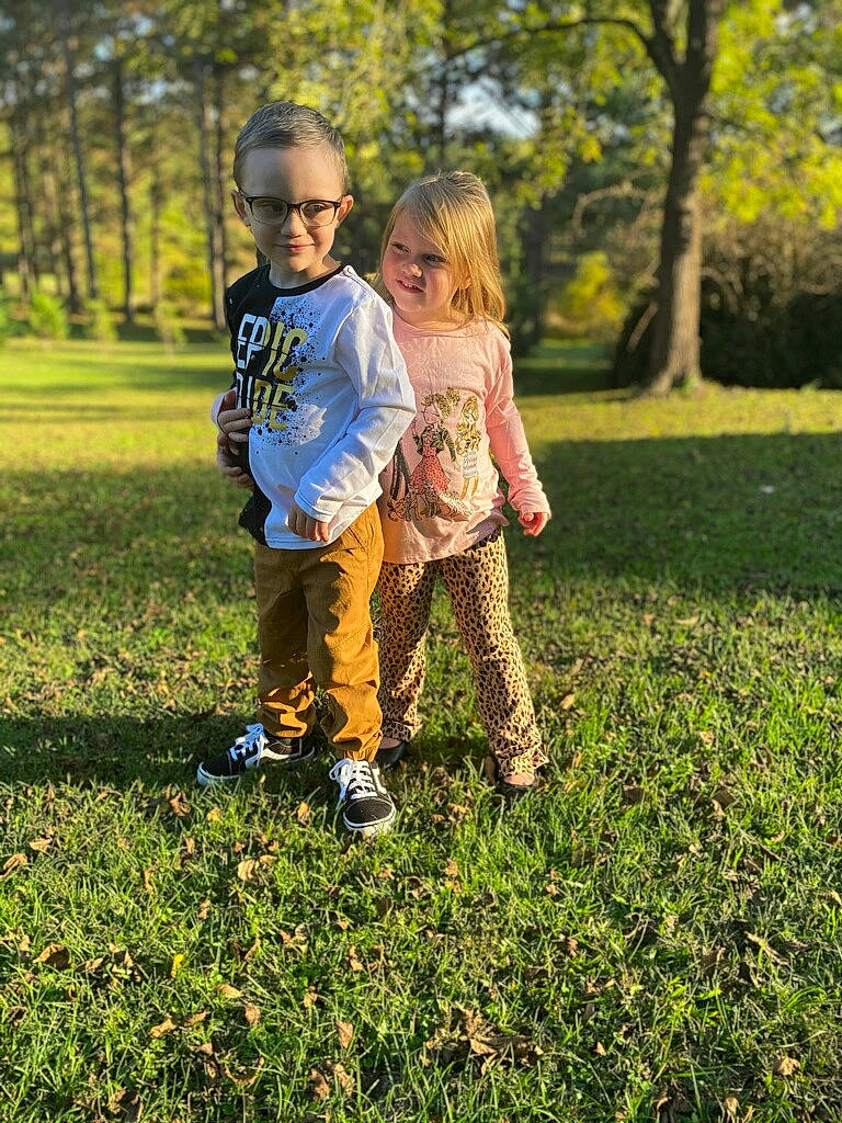 Dustyn is registered to the contest to win money with this photo: branch, gesture, grass, grass_family, grassland, hair, happy, joy, leisure, meadow, natural_landscape, people_in_nature, person, plant, playing_with_kids, shoe, sneakers, summer, sunlight, toddler