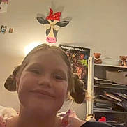 Ellieana is registered to the contest to win money with this photo: bookshelf, casual, child, cow, decor, furniture, girl, happy, indoor, painting, pigtails, portrait, poster, room, shelf, smile, teddy_bear, toy, wall, young