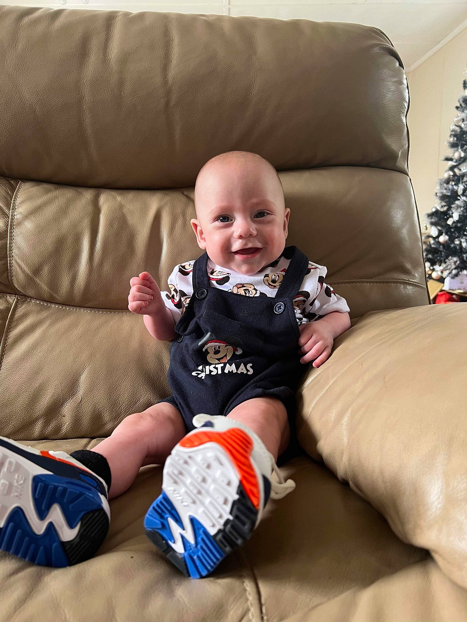 Kaelyn is registered to the contest to win money with this photo: baby, baby_toddler_clothing, child, comfort, couch, flooring, fun, furniture, happy, human_leg, joy, knee, living_room, person, product, room, sitting, sleeve, smile, sock