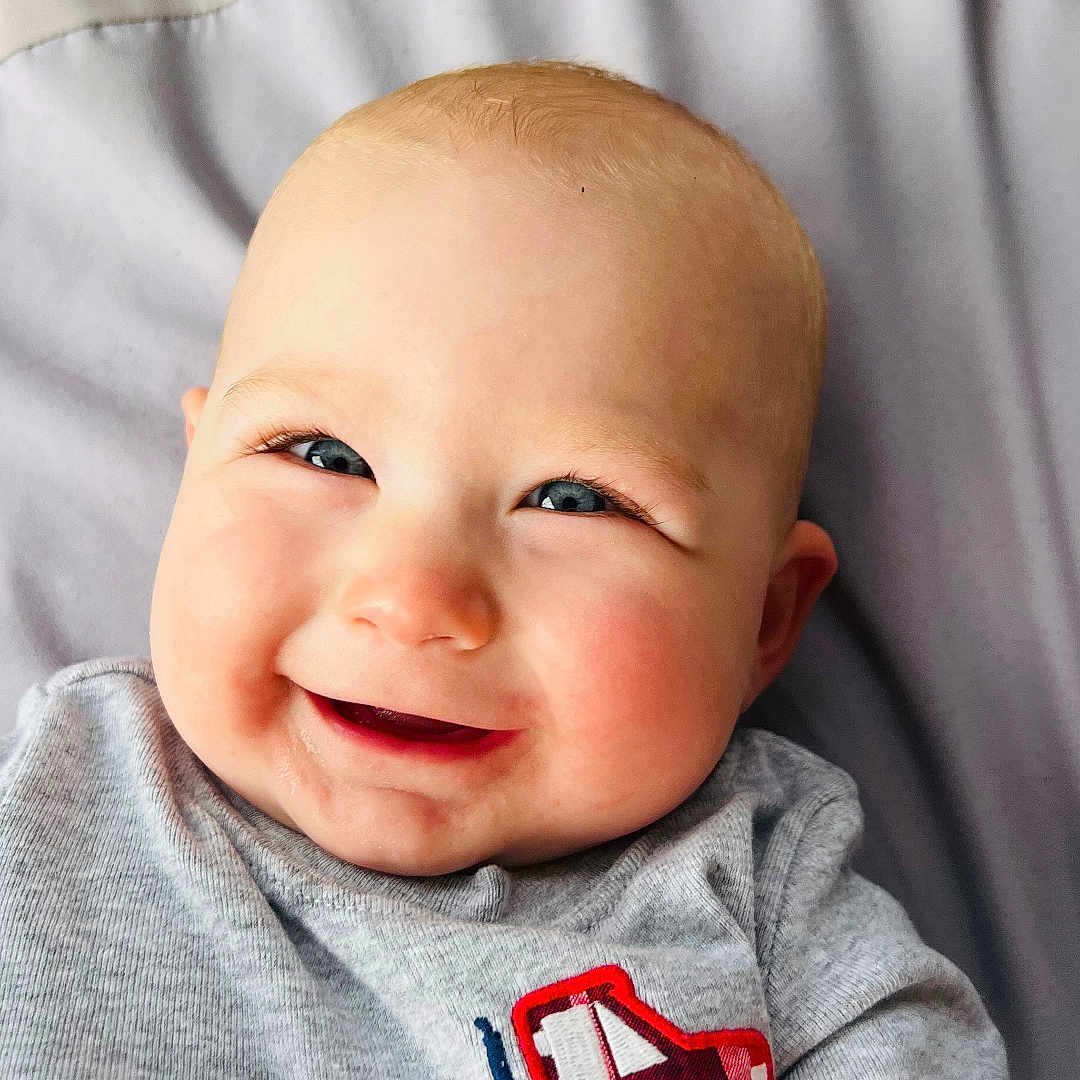 Waylon joined the competition — help win amazing prizes! baby, bed, bodypart, clothing, crib, cushion, face, finger, furniture, hand, happy, head, homedecor, laughing, newborn, person, photography, portrait, smile, t_shirt