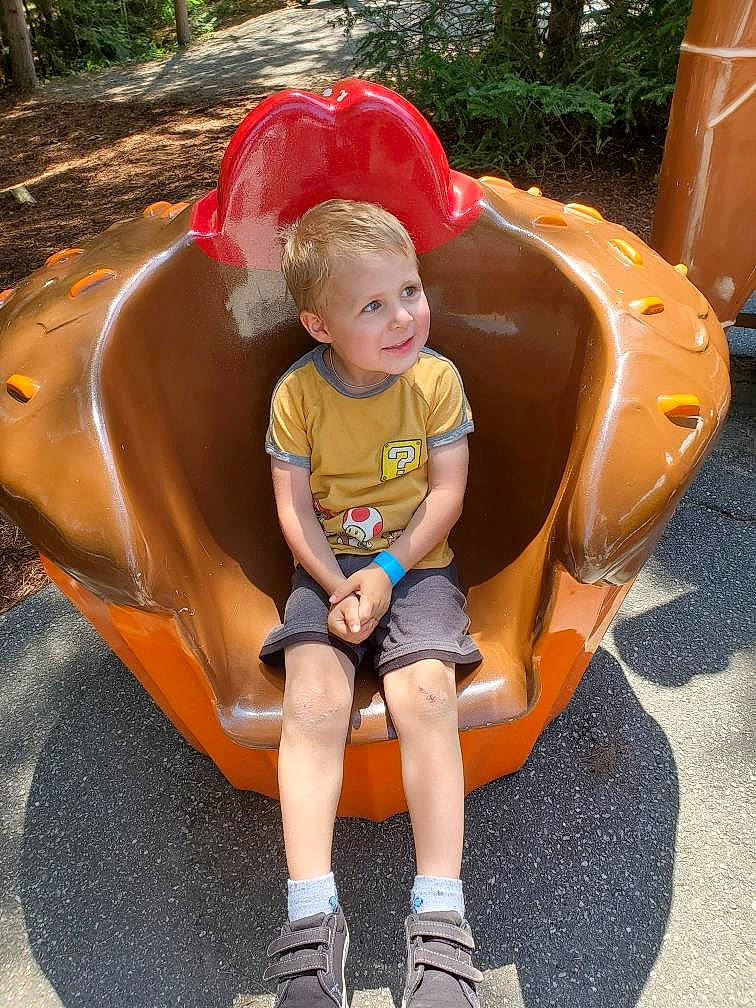 Robert is registered to the contest to win money with this photo: baby_toddler_clothing, child, comfort, fun, grass, lap, leisure, outdoor_recreation, person, photograph, plant, play, playground, recreation, shorts, sitting, snapshot, thigh, toddler, tree