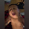 baby, infant, child, portrait, indoor, supported, adult_hand, open_mouth, facial_expression, bare_chest, sitting, close_up, hair, eyes, nose, mouth, laundry_basket, chair, blanket, home
