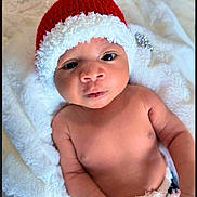 Noah joined the competition — help win amazing prizes! arm, baby, christmas, cute, eyes, face, hand, hat, holiday, indoors, infant, lying_down, mouth, newborn, portrait, red_hat, skin, soft_texture, warm, white_fluffy_blanket