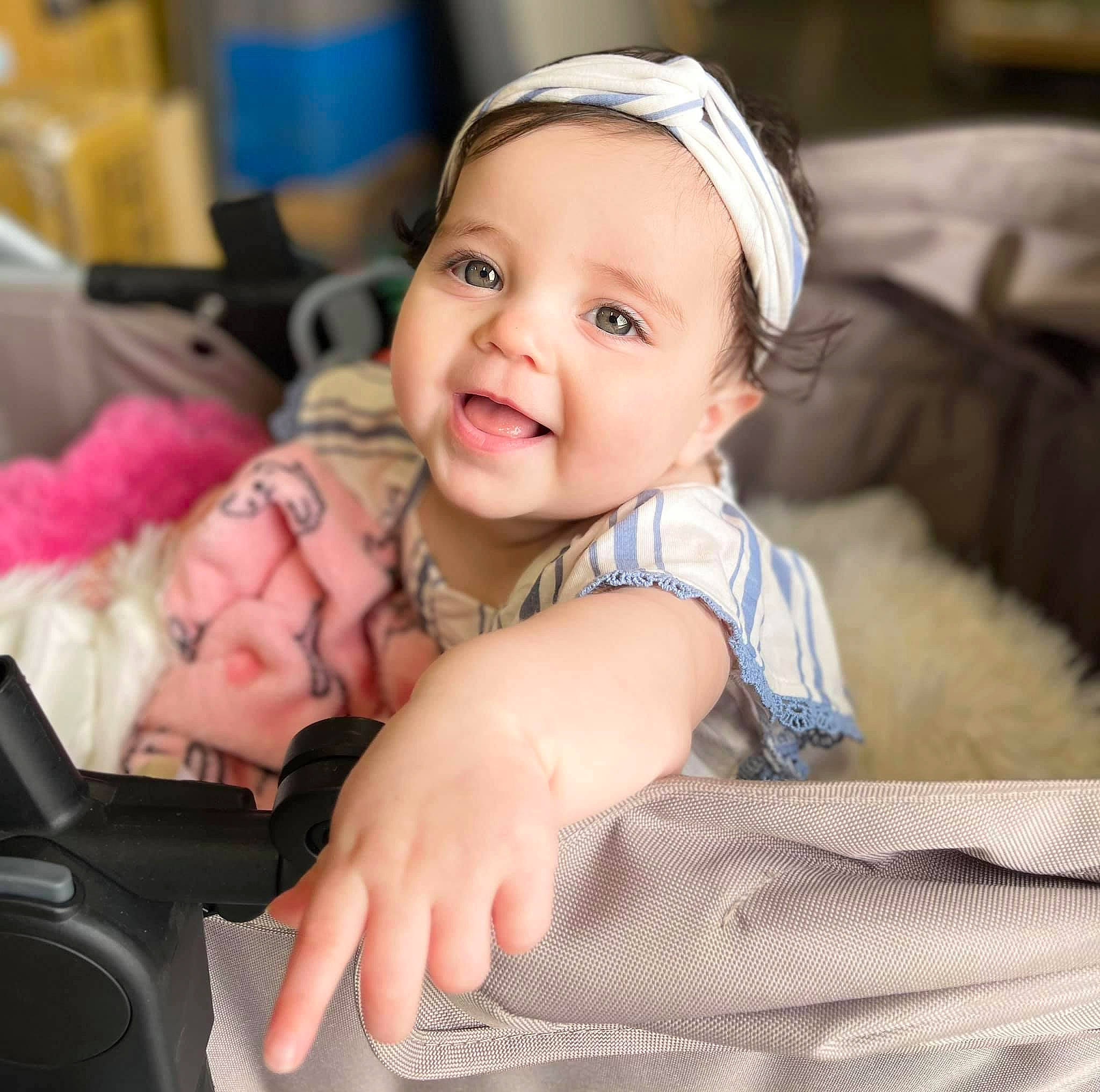 Sophia is registered to the contest to win money with this photo: auto_part, baby, baby_in_car_seat, baby_products, baby_toddler_clothing, car_seat, cheek, child, comfort, face, fun, happy, iris, laugh, person, portrait_photography, sitting, skin, smile, thumb