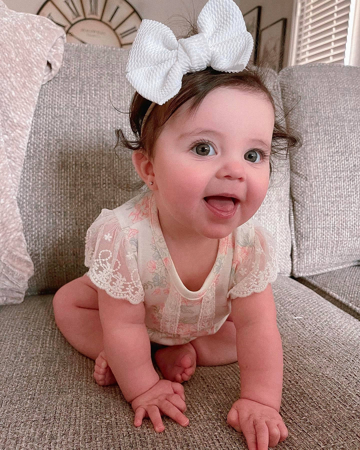 Sophia is registered to the contest to win money with this photo: baby, baby_toddler_clothing, cheek, child, comfort, eye, eyelash, face, floor, flooring, happy, headband, headpiece, iris, person, pink, product, skin, sleeve, smile