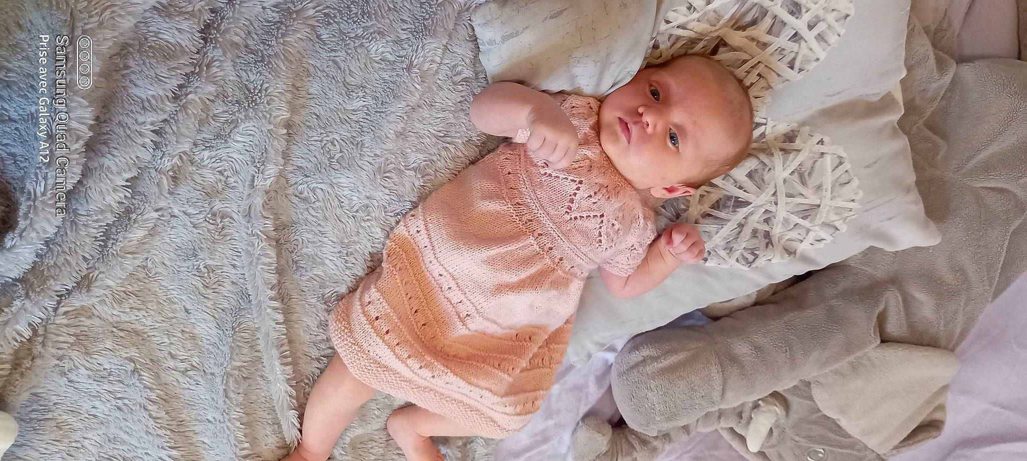 Alexia a rejoint le concours — aidez-le/la à gagner de superbes lots ! baby, baby_products, baby_sleeping, baby_toddler_clothing, bedtime, child, comfort, dress, embellishment, iris, leg, linens, pattern, peach, person, sitting, skin, sleeve, textile, toddler