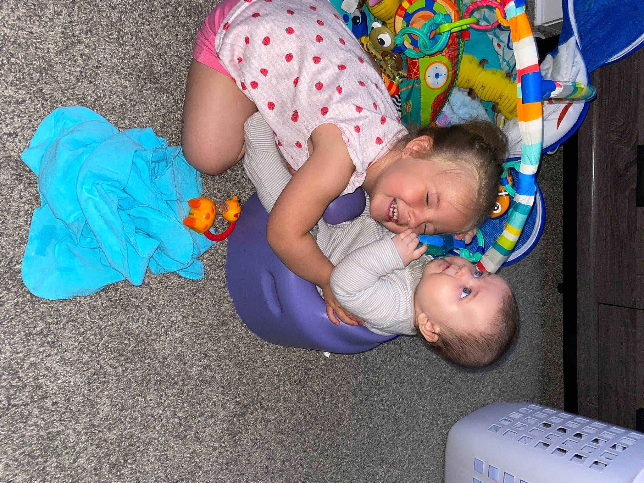 Kylie is registered to the contest to win money with this photo: arm, baby, baby_products, baby_toddler_clothing, child, comfort, flooring, fun, happy, head, human_body, human_leg, joy, lap, leg, pattern, people, person, play, sitting