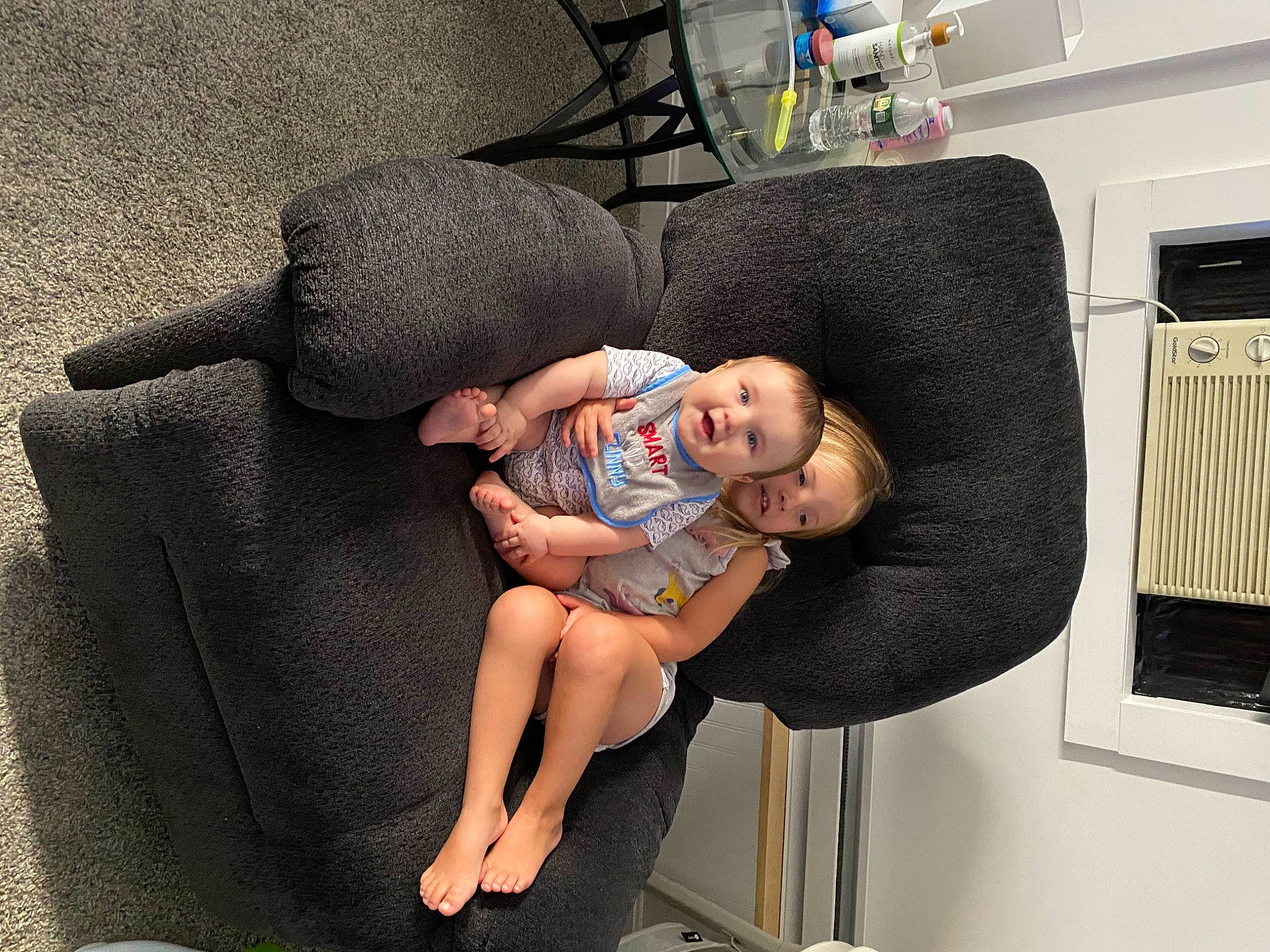 Jordan is registered to the contest to win money with this photo: baby, baby_products, baby_toddler_clothing, child, comfort, foot, fun, health_care, human_leg, knee, lap, leg, leisure, person, room, sandal, sitting, smile, sock, thigh