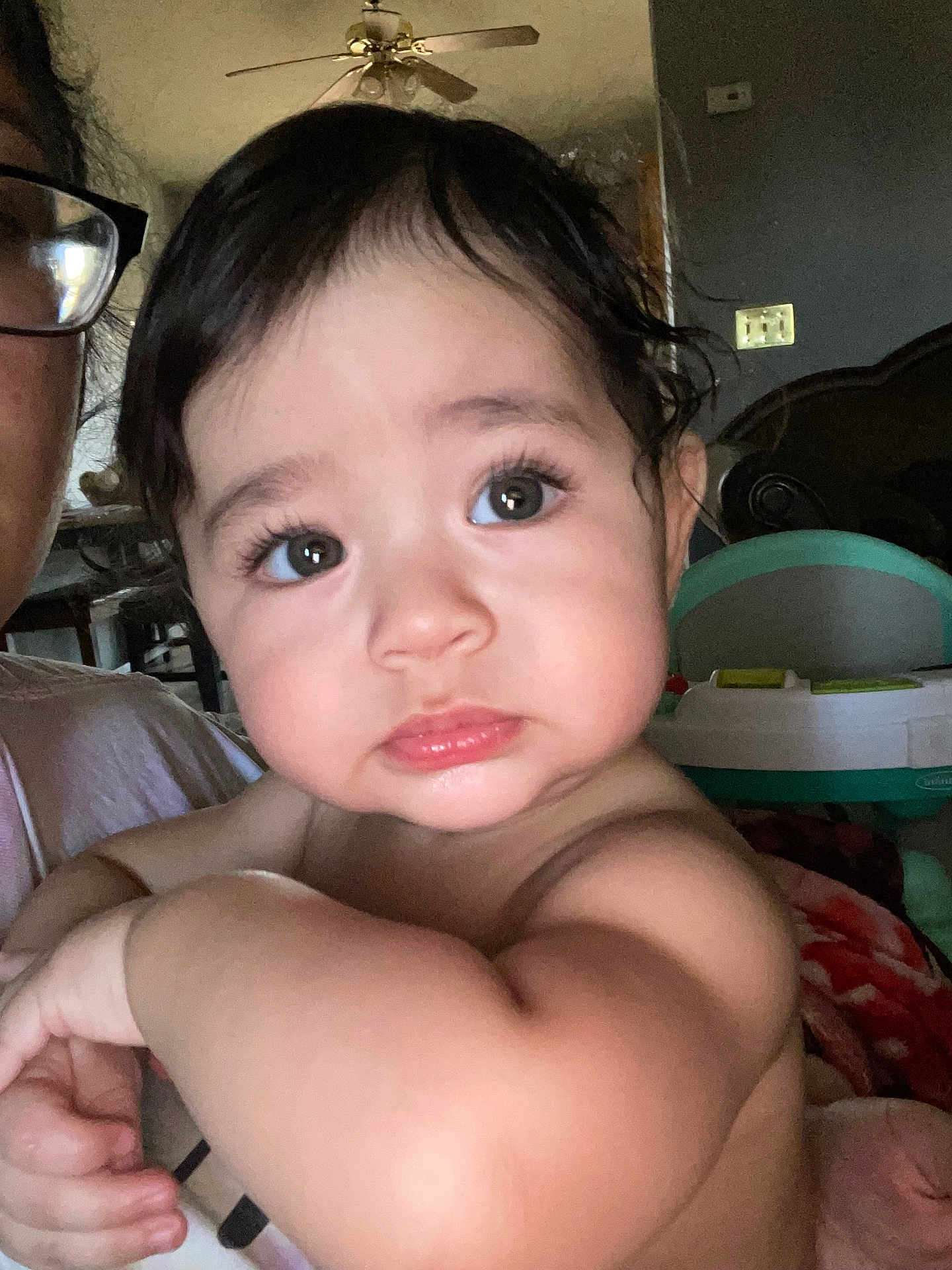 Weston joined the competition — help win amazing prizes! adult, arm, baby, blanket, ceiling_fan, child, closeup, expression, eyelashes, eyes, face, furniture, glasses, holding, home, indoor, person, portrait, skin, toy
