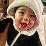 baby, child, panda_costume, hood, smiling, happy, cute, indoor, face, portrait, young_child, clothing, black_and_white, zipper, person, funny_costume, infant, cheerful, closeup, expression
