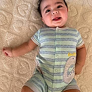 Weston joined the competition — help win amazing prizes! baby, infant, smiling, onesie, striped_clothing, dinosaur_patch, blanket, textured_blanket, cute, happy, lying_down, portrait, child, toddler, indoor, soft_lighting, small_person, face, head, chubby_cheeks
